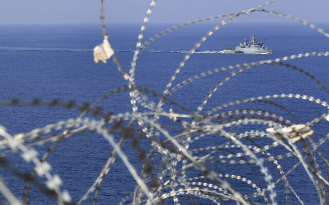 A UNIFIL Navy vessel seen through barbed wires patrols in the Mediterranean Sea, next to a UN post along the border known as Ras Naqoura, where Lebanese and Israeli delegations met to finalize a maritime border agreement, off the southern town of Naqoura, Lebanon, October 27, 2022. (Mohammed Zaatari/AP)