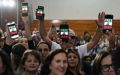 People hold up phones displaying the words 'Free Iran' as US President Joe Biden speaks at a campaign event in support of Rep. Mike Levin, D-Calif., Thursday, Nov. 3, 2022, in San Diego. (AP Photo/Patrick Semansky)