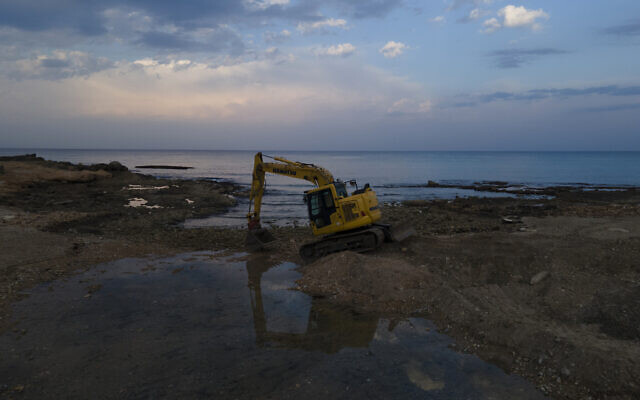 A heavy digger works in a meeting point between a stream and the Mediterranean Sea marine natural reserve of Rosh Hanikra in northern Israel, Oct. 26, 2022. (AP Photo/Ariel Schalit)