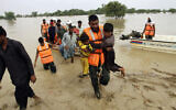 Army troops evacuate people from a flood-hit area in Rajanpur, district of Punjab, Pakistan, August 27, 2022. (Asim Tanveer/AP)