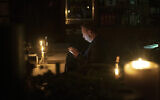 A man sits in a caffe during a blackout in Kyiv, Ukraine, November 4, 2022. (Andrew Kravchenko/AP)