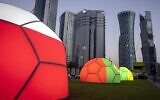 Domes featuring different national colors are displayed near the Doha Exhibition and Convention Center where soccer World Cup draw will be held, in Doha, Qatar, March 31, 2022. (Darko Bandic/AP)