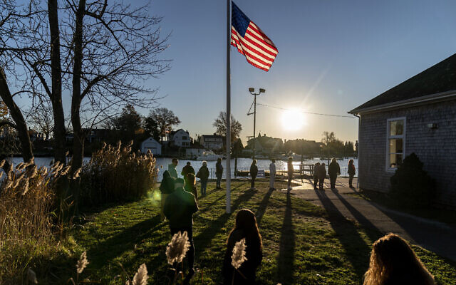 Voters line up to cast their ballots in the US midterm election at the Aspray Boat House in Warwick, Rhode Island, November 8, 2022. (AP Photo/David Goldman)