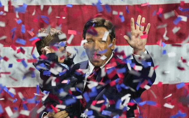 Florida Republican Gov. Ron DeSantis holds his son Mason as he celebrates winning reelection, at an election night party in Tampa, Florida, November 8, 2022. (Rebecca Blackwell/AP)