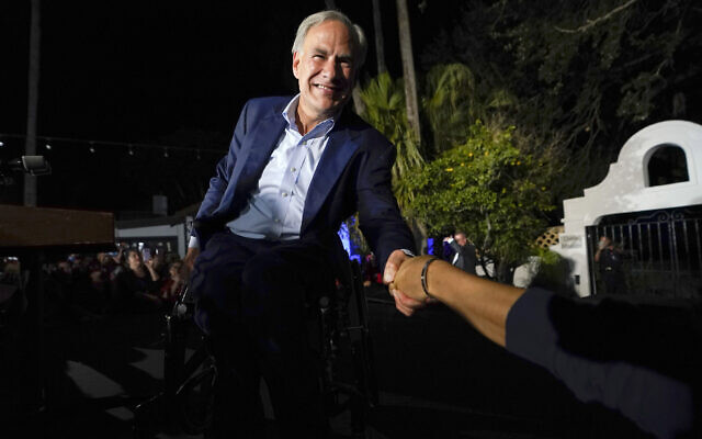 Texas Gov. Greg Abbott shakes hands with a supporter as he arrives to speak during an election night campaign event in McAllen, Texas, November 8, 2022,. (David J. Phillip/AP)