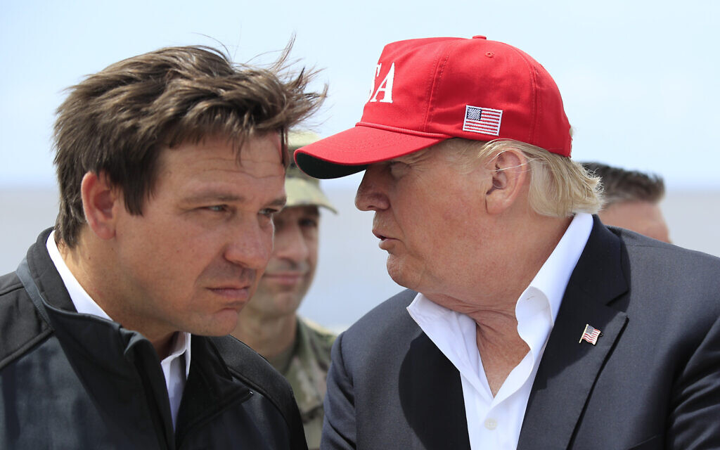 File: US President Donald Trump talks to Florida Gov. Ron DeSantis, left, during a visit to Lake Okeechobee and Herbert Hoover Dike at Canal Point, Fla., March 29, 2019. (AP Photo/Manuel Balce Ceneta, File)