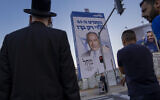 People walk past an election campaign billboard showing Benjamin Netanyahu, former Israeli prime minister and the head of Likud party, in Bnei Brak, Israel, October 25, 2022. (Oded Balilty/AP)