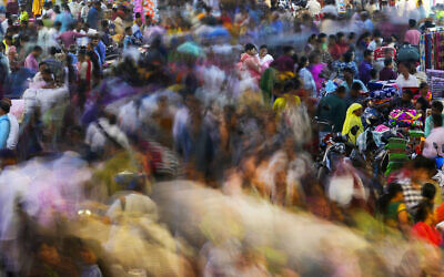 People move through a market in Mumbai, India, November 12, 2022. (AP Photo/Rajanish Kakade)