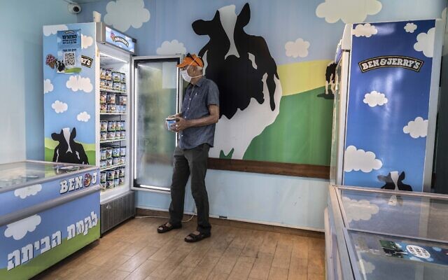 Illustrative: An Israeli shops at the Ben & Jerry's ice-cream factory in the Be'er Tuvia Industrial area on July 20, 2021. (AP Photo/Tsafrir Abayov, File)
