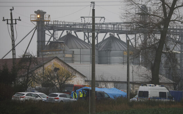 Police officers work outside a grain depot where, according to the Polish government, an explosion of a Russian-made missile killed two people in Przewodow, Poland, November 16, 2022. (Michal Dyjuk/AP)