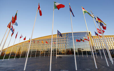 Flags of NATO members fly outside the NATO headquarters, November 16, 2022 in Brussels. (AP Photo/Olivier Matthys)