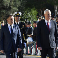 Defense Minister Benny Gantz, right, and his Greek counterpart Nikos Panagiotopoulos, inspect an honor guard before their meeting at the Greek Ministry of Defense, in Athens, Greece, Nov. 18, 2022. (AP Photo/Michael Varaklas)