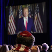 People listen as former president Donald Trump speaks remotely to an annual leadership meeting of the Republican Jewish Coalition, November 19, 2022, in Las Vegas. (AP Photo/John Locher)