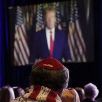 People listen as former US President Donald Trump speaks remotely to an annual leadership meeting of the Republican Jewish Coalition November 19, 2022, in Las Vegas. (AP Photo/John Locher)