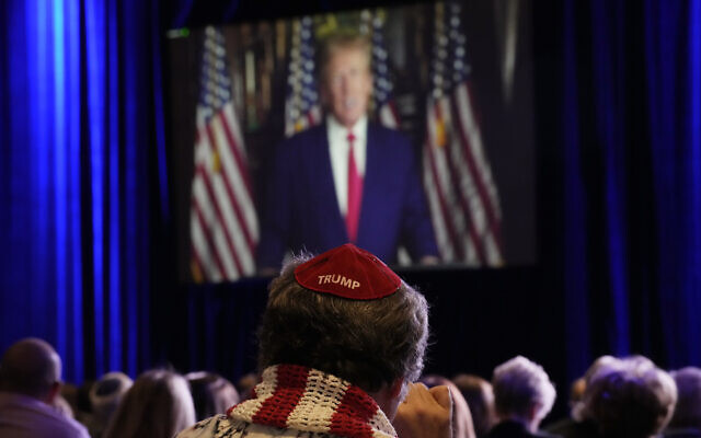 People listen as former US President Donald Trump speaks remotely to an annual leadership meeting of the Republican Jewish Coalition November 19, 2022, in Las Vegas. (AP Photo/John Locher)