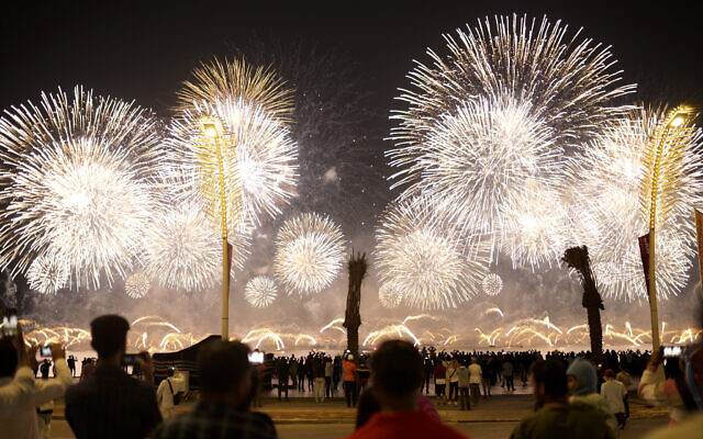 Fans watch fireworks after the World Cup inauguration match between Qatar and Ecuador at the Corniche sea promenade in Doha, Qatar, Sunday, November 20, 2022. (AP/Francisco Seco)
