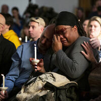 Tyrice Kelley, center right, a performer at Club Q, is comforted during a service held at All Souls Unitarian Church following an overnight fatal shooting at the gay nightclub, in Colorado Springs, Colo., on Sunday, Nov. 20, 2022. (Parker Seibold/The Gazette via AP)
