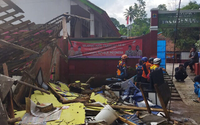 Rescuers inspect a school damaged by an earthquake in Cianjur, West Java, Indonesia, Nov. 21, 2022. (BASARNAS via AP)