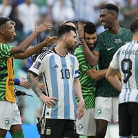 Argentina's Lionel Messi standing beside Saudi Arabia's players celebrating after winning the World Cup group C soccer match between Argentina and Saudi Arabia at the Lusail Stadium in Lusail, Qatar, November 22, 2022. (AP Photo/Natacha Pisarenko)