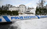 A police tape cordons an area outside a house where Swedish Security Service allegedly arrested two people on suspicions of espionage in a predawn operation in Stockholm, November 22 2022. (Fredrik Sandberg/TT News Agency via AP)