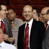Manchester United board members Bryan Glazer, left, Avi Glazer, center, and Joel Glazer take their seats in the stands before their side's Champions League third qualifying round first leg soccer match against Debrecen at Old Trafford Stadium, Manchester, England, on Aug. 9, 2005. (AP/Jon Super, File)