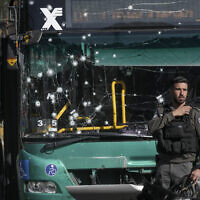 Israeli police inspect the scene of a terrorist bombing at a bus stop in Jerusalem, November 23, 2022. (AP Photo/Mahmoud Illean)