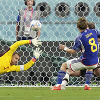 Japan's Ritsu Doan scores his side's first goal against Germany's goalkeeper Manuel Neuer, left, during the World Cup match between Germany and Japan, at the Khalifa International Stadium in Doha, Qatar, November 23, 2022. (AP Photo/Matthias Schrader)