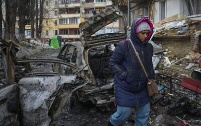 A woman walks by a house damaged during Russian shelling in the town of Vyshgorod outside the capital Kyiv, Ukraine, November 24, 2022. (AP Photo/Efrem Lukatsky)