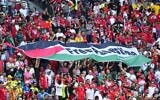 Supporters of Tunisia hold a flag that reads 'Free Palestine' during the World Cup group D soccer match between Tunisia and Australia at the Al Janoub Stadium in Al Wakrah, Qatar, November 26, 2022. (AP/Petr David Josek)