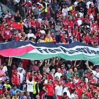 Supporters of Tunisia hold a flag of Palestine that reads "Free Palestine" during the World Cup group D soccer match between Tunisia and Australia at the Al Janoub Stadium in Al Wakrah, Qatar, Nov. 26, 2022. (AP Photo/Petr David Josek)