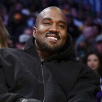 Kanye West watches the first half of an NBA basketball game between the Washington Wizards and the Los Angeles Lakers in Los Angeles, on March 11, 2022. (AP/Ashley Landis)