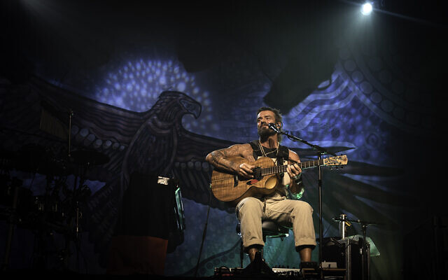 Australian indie rocker Xavier Rudd played Tel Aviv on November 12, 2022, in a rousing solo show at Hangar 11, beneath a massive cloth backdrop depicting a Bunjil totem. Bunjil was an Aboriginal mythical leader often depicted as an eagle, who is believed to be the protector of the natural world, his people and their beliefs. (courtesy, Dawid Rygielski Photography)