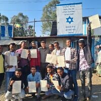 The 12 graduates of a program to train kosher slaughterers in Ethiopia so the Jewish community can have regular access to kosher meat, along with a rabbi from Israel who works with the community (center), in November 2022. (Ohr Torah Stone)