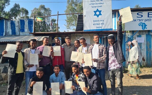 The 12 graduates of a program to train kosher slaughterers in Ethiopia so the Jewish community can have regular access to kosher meat, along with a rabbi from Israel who works with the community (center), in November 2022. (Ohr Torah Stone)