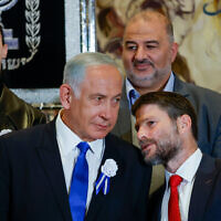 Likud leader MK Benjamin Netanyahu (left) speaks with Religious Zionist party head MK Bezalel Smotrich at the swearing-in ceremony of the 25th Knesset in Jerusalem, November 15, 2022. (Olivier Fitoussi/Flash90)