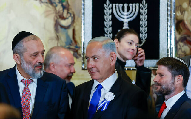 Likud leader MK Benjamin Netanyahu, center, with Shas leader MK Aryeh Deri, left, and Religious Zionism head MK Bezalel Smotrich at a swearing-in ceremony of the 25th Knesset, at the Israeli parliament in Jerusalem, November 15, 2022.(Olivier Fitoussi/Flash90)