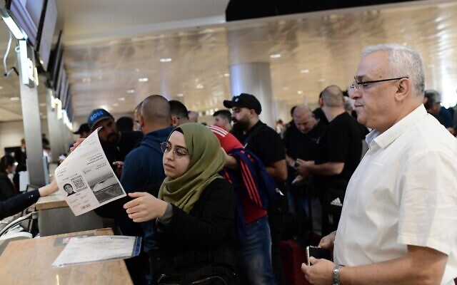 People check in at a counter in Ben Gurion international airport in Tel Aviv, the first commercial flight from Israel to Doha for the World Cup 2022 tournament, on November 20, 2022. (Tomer Neuberg/Flash90)