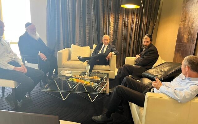 Likud chief Benjamin Netanyahu (center) meets with UTJ head Yitzchak Goldknopf (second from left) and other party officials, with Likud negotiator Yariv Levin (right) in a Jerusalem hotel on November 6, 2022. (Courtesy)