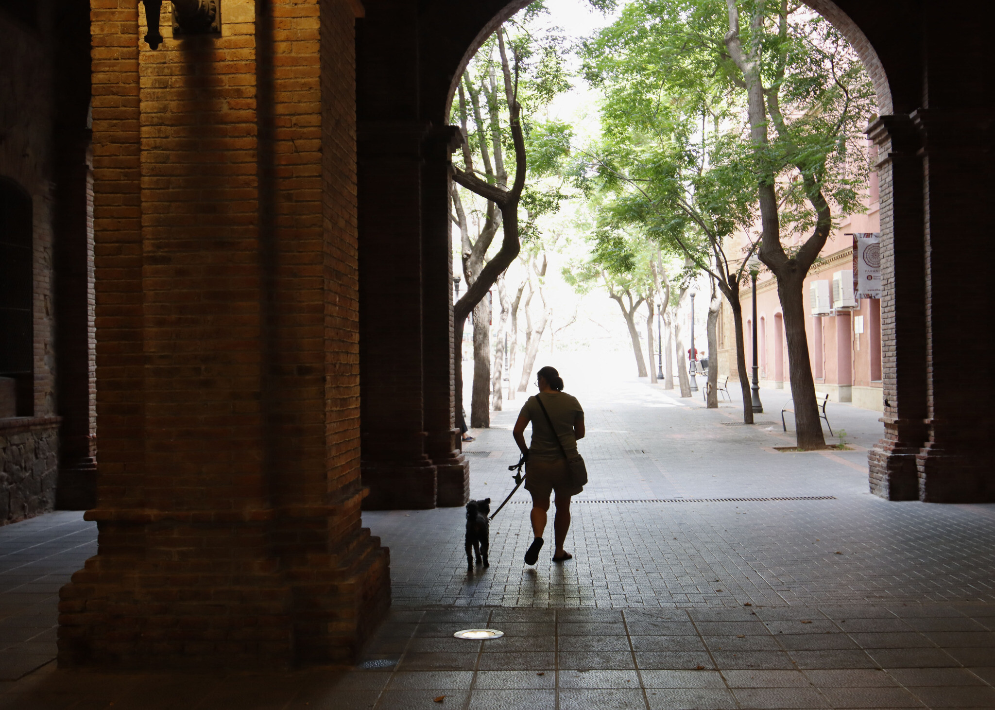Julie Bronder walks through her neighborhood with her dog Koval in Barcelona, Spain, on June 20, 2022. (Raquel G. Frohlich)