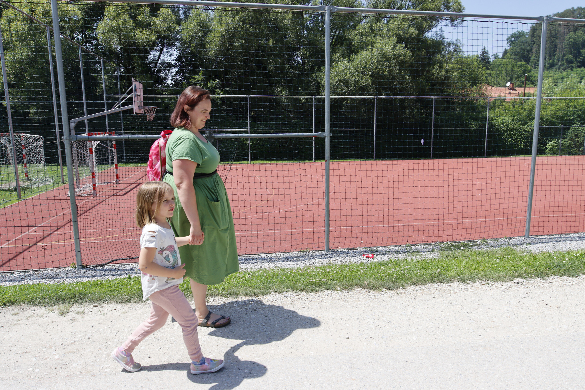 Amy Feineman walks home with her daughter Lily after school in Graz, Austria, on June 27, 2022. (Raquel G. Frohlich)