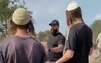 Settler youth seen confronting a Palestinian farmer in a Palestinian-owned olive grove in the West Bank, as farmers said they found dozens of trees cut down in Turmus Ayya, near Ramallah, November 7, 2022. (Video screenshot)
