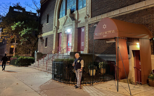 A man stands outside Temple Beth El synagogue in Jersey City, New Jersey, Nov. 3, 2022. (AP Photo/Ted Shaffrey)