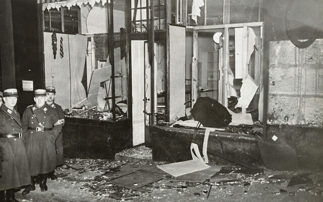 German Nazis stand by ransacked Jewish property during Kristallnacht, most likely in the town of Fuerth, Germany, on Nov. 10, 1938. (Yad Vashem via AP)