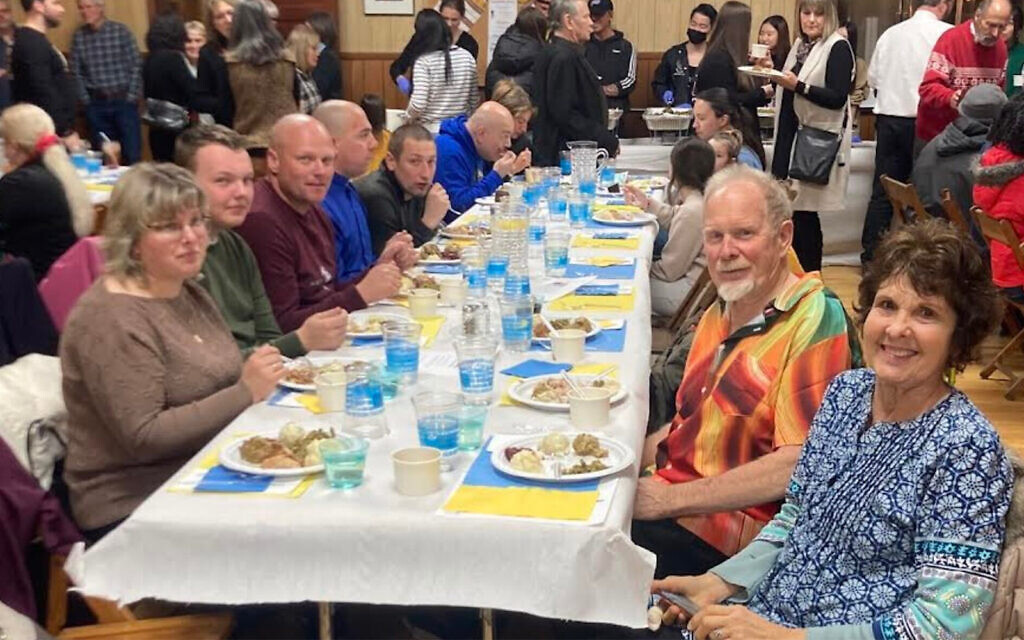 Ukrainian evacuees celebrate a pre-Thanksgiving meal at the Ukrainian American Civic Center in Buffalo, New York. (Courtesy of Jewish Federations of North America via JTA)