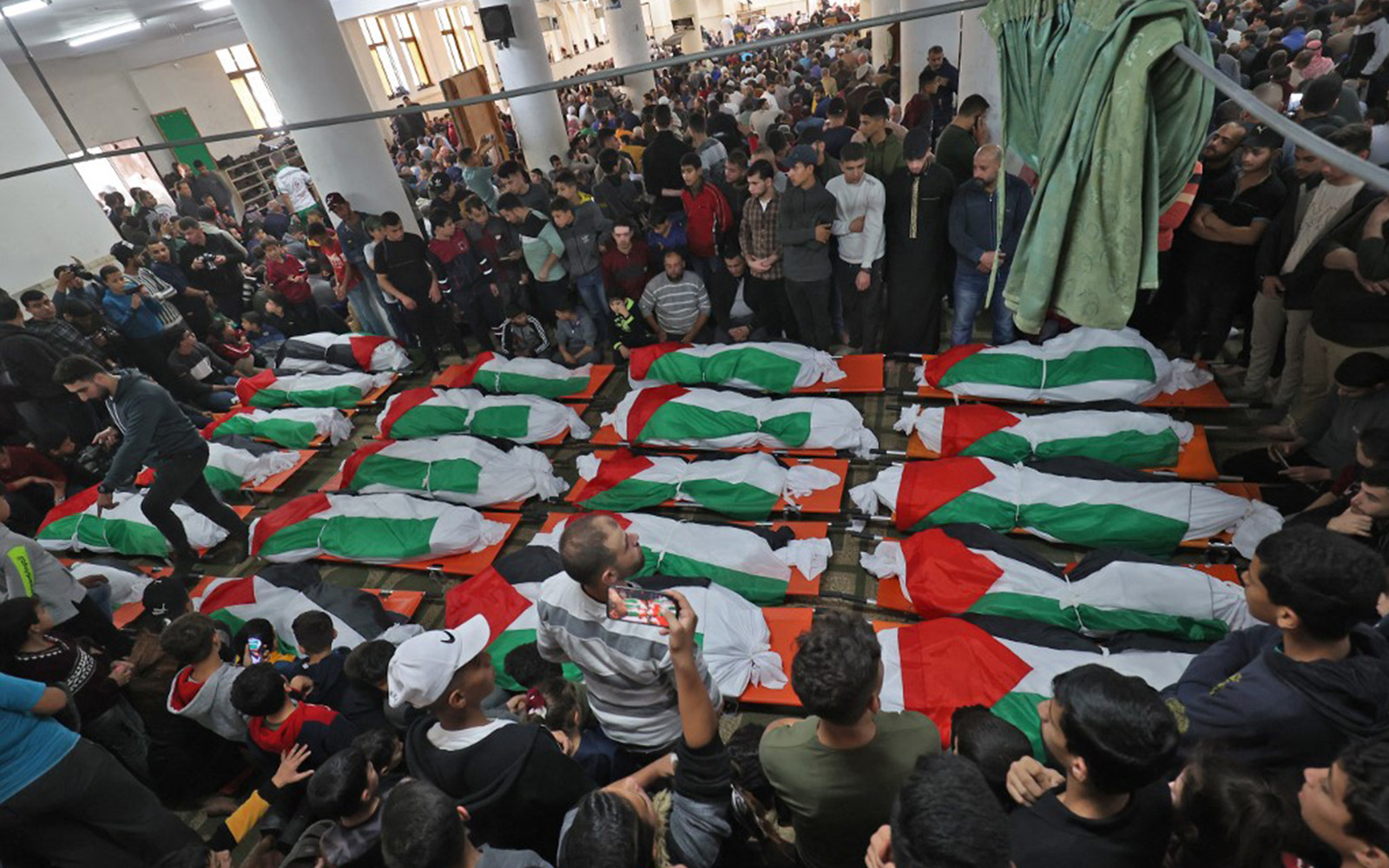 Thousands mourn 21 victims of devastating apartment fire in Gaza The