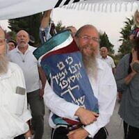 Head of the makeshift Homesh yeshiva Rabbi Elishama Cohen at an inauguration ceremony for a Torah scroll in the Homesh illegal outpost. (Courtesy Homesh Yeshiva)