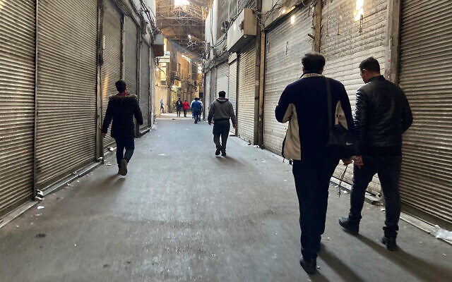 People walk through closed shops in Tehran's Grand Bazaar, Iran, November 15, 2022. (AP Photo/Vahid Salemi)