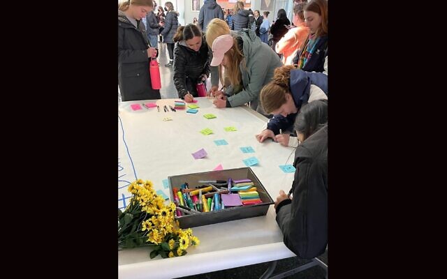 Brandeis University students assemble messages in honor of their classmate who died in a shuttle bus crash that injured dozens of Brandeis students, following a gathering in the Shapiro Student Center, Nov. 20, 2022. (Penny Schwartz via JTA)