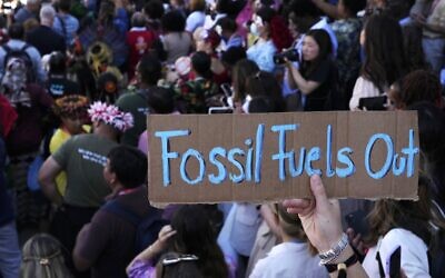 FILE - A sign reading "fossil fuels out" is displayed during a demonstration at the COP27 UN Climate Summit, on November 12, 2022, in Sharm el-Sheikh, Egypt.  (AP Photo/Peter Dejong, File)