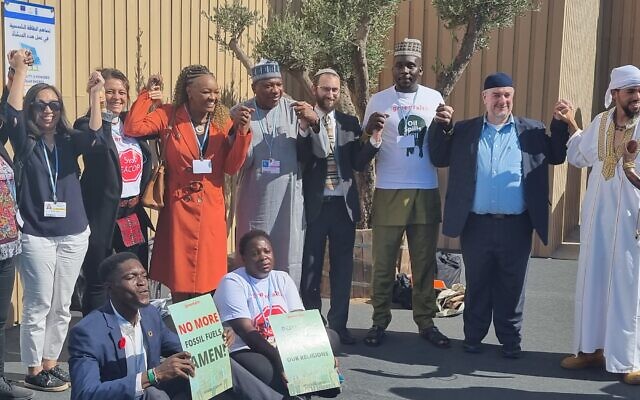 Religious leaders call to stop using fossil fuels at at the UN COP27 climate conference in Sharm el-Sheikh, Egypt, November 9, 2022.  Among them (center) is Rabbi Yonatan Neril, founder and director of the Israeli Interfaith Center for Sustainable Development. (Courtesy)
